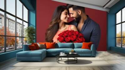 young couple giving romantic pose with red roses at home Wall mural