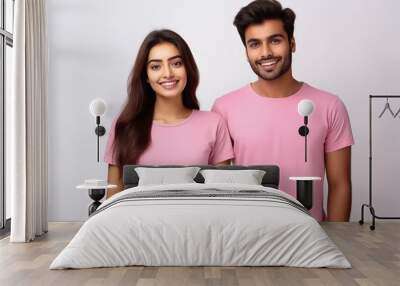 Young couple in pink color t shirts on white background Wall mural