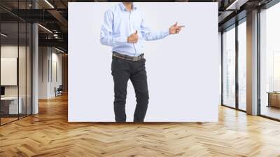 Young Indian Man Showing Direction With Hand Wall mural