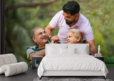 Young Indian man with his parents at park Wall mural