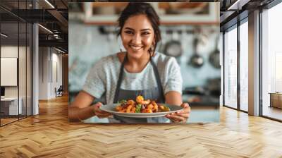 young indian woman holding shrimp plate Wall mural