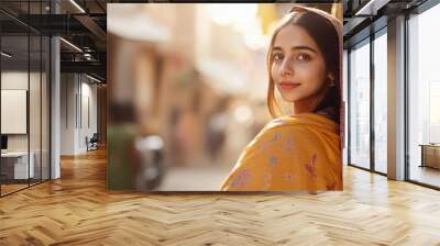 young indian woman standing at city street Wall mural