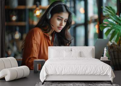 young indian woman working on laptop Wall mural