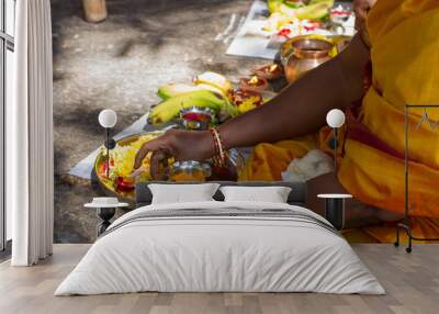 A close up of a Hindu woman's hands as she performs worship (puja) Wall mural