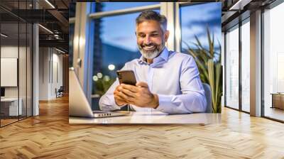 Happy businessman using smartphone. Wall mural