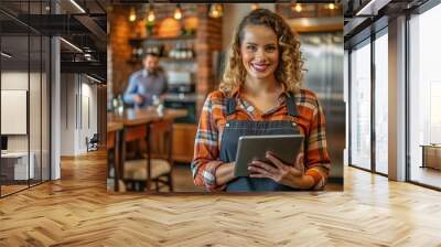 Smiling waitress holding a tablet in a restaurant. Wall mural