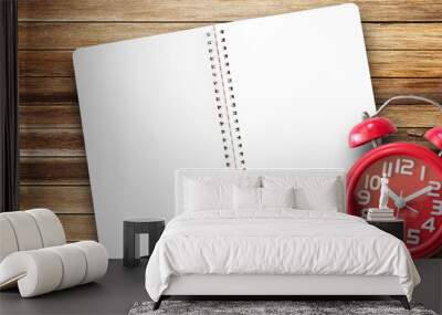 Top view with paper notepad,red alarm clock and coffee cup on wood table background Wall mural