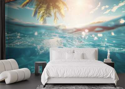 Underwater photo of the inside of the sea with sunrays and palm tree which can bee seen on surface through the water, clear blue tone, summer vibes Wall mural