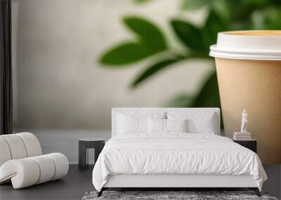 A close-up shot of an eco-friendly paper coffee cup with a white lid, showcasing its sustainable design and suitability for takeaway coffee. The cup is positioned against a blurred background of green Wall mural