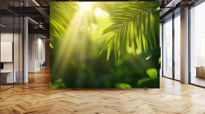 A close-up shot of lush green palm leaves with sunlight streaming through, creating a sense of peace, tranquility, and the beauty of nature. This image evokes feelings of escape, relaxation, and the s Wall mural