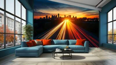 A highway stretches towards a city skyline at sunset, with the lights of cars creating streaks of color on the asphalt.  The image symbolizes progress, urban life, and the pursuit of opportunity. Wall mural