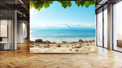 A serene tropical beach scene with a sandy shoreline and calm turquoise water. The sun shines through lush green foliage, creating a beautiful natural frame for the idyllic setting. Wall mural