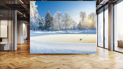 A serene winter scene with a snow-covered golf course, glistening trees, and a sunbeam illuminating the frozen green. It represents peace, tranquility, resilience, and the beauty of nature in winter. Wall mural