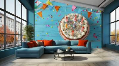 Birthday Cake Celebration - A delicious birthday cake with lit candles is surrounded by colorful confetti and decorations on a rustic wooden table, creating a festive and joyful atmosphere. - A delici Wall mural