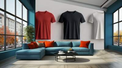 Five blank t-shirts in different colors hanging against a white background. Perfect for showcasing your designs and creating marketing materials. Wall mural