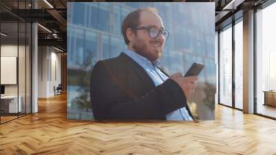 Cheerful overweight office worker surfing internet relaxing near business center. Wall mural