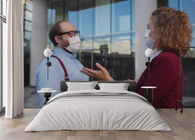 Colleagues in medical mask communicating meeting outdoors Wall mural