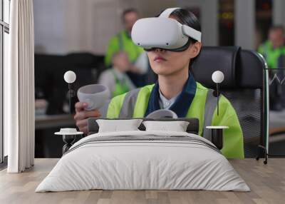 Young woman engineer test vr goggles and controllers in modern industrial laboratory Wall mural