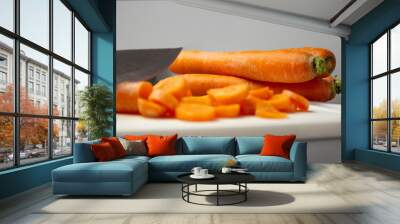 close-up of carrots lying on a white board Wall mural