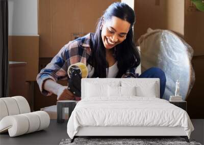 After moving house the hard part comes unpacking. Shot of a young woman packing up to move. Wall mural