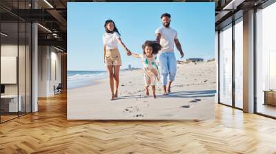 Come this way. Full length shot of an affectionate young family of three taking a walk on the beach. Wall mural