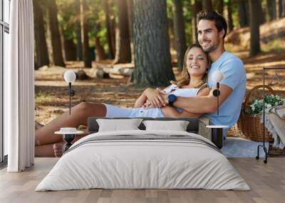 I love it when its just us. Shot of a young couple having a picnic in the forest. Wall mural