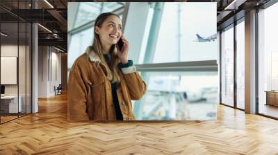 Phone call, travel and woman talking at airport, chatting or speaking to contact in lobby. Communication, mobile and happy female with smartphone for networking while waiting for flight departure. Wall mural