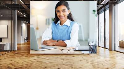 Portrait of a young entrepreneur networking with clients online using her laptop. One happy female corporate intern browsing the internet and typing and sending emails for her manager Wall mural