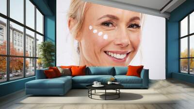 Skincare, face cream and portrait of mature woman in studio for wellness, beauty and care on grey background. Facial, product or sunscreen by lady relax in luxury, cosmetic and lotion while isolated Wall mural