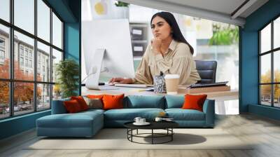 Thinking, attention and business woman on computer working by desk in design company office building. Idea, vision and innovation with employee reading email or looking at work online Wall mural