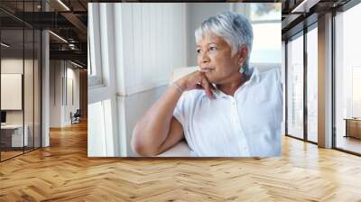 Thinking back.... Cropped shot of an attractive senior woman looking nostalgic while sitting in the old age home. Wall mural