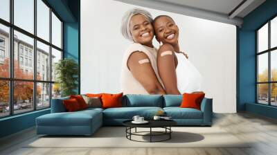 Vaccine, plaster and portrait of black women after an injection as a medical cure isolated in a white background. Healthcare, wellness and happy friends in a hospital or clinic for medicine together Wall mural