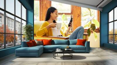 Woman, smartphone and coffee, smile at social media and communication, technology and scroll internet. Online chat, happy female relax at home with hot drink, mobile app or games with connectivity Wall mural