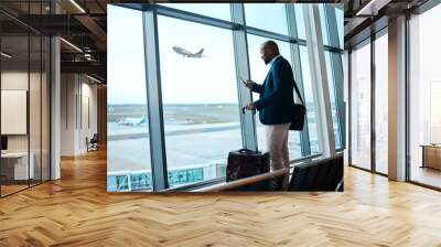 Black man with phone, airport window and plane taking off, checking flight schedule terminal for business trip. Technology, travel and businessman reading international travel restrictions app online Wall mural