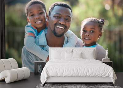 Father is a verb. Its something you do. Not just who you are. a man spending time outdoors with his two children. Wall mural