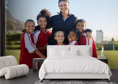 Football, happy and girl team with coach on a sport soccer field after training or a game. Teamwork and collaboration with a happy group of female athletes play for fun, to win and succeed Wall mural