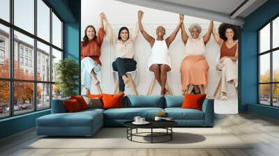 Happy women, business and teamwork celebration in waiting room for hiring, job opportunity or success at office. Group of woman employees holding hands in happiness for team win or victory in a row Wall mural