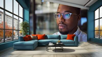 Information technology businessman with glasses and computer reflection for night vision, eyes healthcare, wellness or innovation. Office black man programmer reading online code software development Wall mural