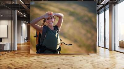 Jobs fill your pockets but adventure fills the soul. Shot of a beautiful young woman wearing a backpack while out hiking. Wall mural