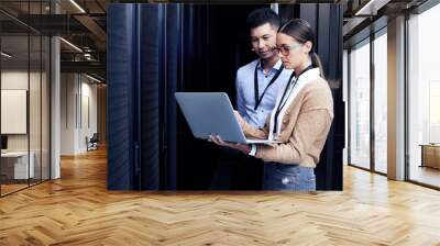 No one knows networking like they do. Shot of two technicians working together in a server room. Wall mural