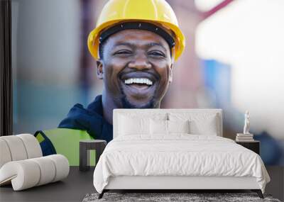 Portrait, logistics and black man smile with helmet or hard hat at shipyard and confident at work. Shipping, business man and manager happy at warehouse, cargo storage or containers for supply chain. Wall mural