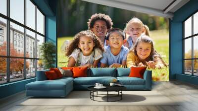 Portrait, smile and children lying on grass in nature on vacation outdoor for learning. Kids, diversity and happiness of group enjoying summer holiday at park or garden, bonding or relaxing together. Wall mural