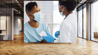 We need to discuss your trmperature. Shot of a doctor showing her patient his temperature. Wall mural