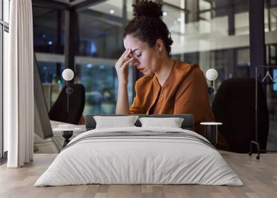 Woman working at night with headache, burnout and stress over social media marketing project or company deadline. Anxiety, exhausted and tired web or online business advertising expert with migraine Wall mural