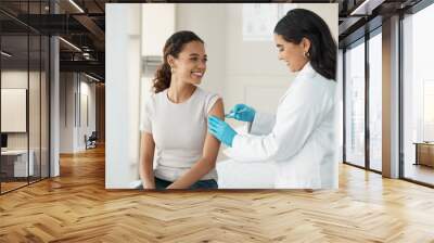 You didnt feel that, did you. an attractive young doctor standing and injecting her patient during a consultation in the clinic. Wall mural