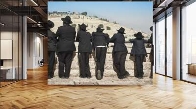 Orthodox Jew students of Yeshivah stand in front of the Western Wall Wall mural