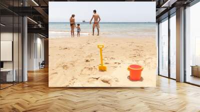 Happy family playing on the beach Wall mural