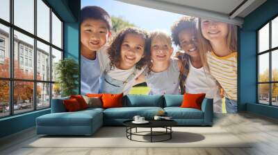 Happy, smile and portrait of kids in a park playing together outdoor in nature with friendship. Happiness, diversity and children friends standing, embracing and bonding in a outside green garden. Wall mural