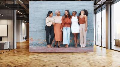 Laughing, diversity and a team of business black women outdoor on a blue brick wall for conversation. Talking, joking or bonding with a female employee and colleague group taking a break outside Wall mural