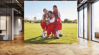 Success, soccer or winner children team hug in stadium for sports exercise, sport game or workout training. Teamwork, Canada or kids in celebrating fitness, wellness or health goal on football field Wall mural